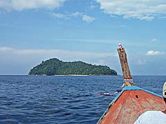 Taking the longtail to the snorkeling grounds